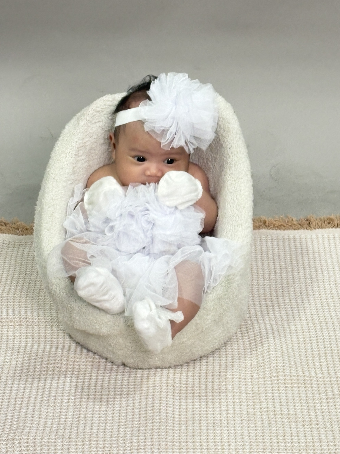 Dorothea Maeve dressed in white with a flower headband